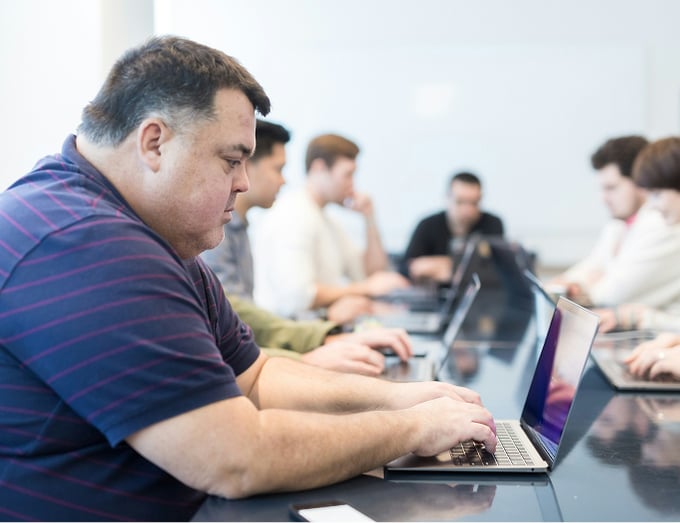 People in a conference room on laptops